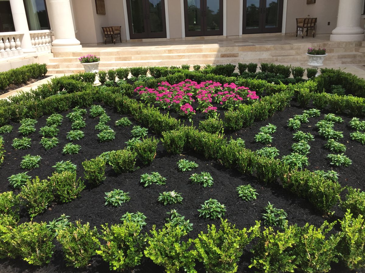 Formal estate garden with boxwood parterre and seasonal color by TruLeaf Landscape Management